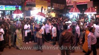 Portable human lamp holders at the Maha Shivratri procession in Varanasi