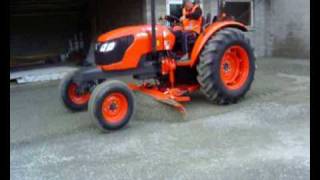 Neilo Kubota M7040 Tractor Grader in operation in restricted space