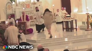 Video shows man charging at priest during prayer at Washington church