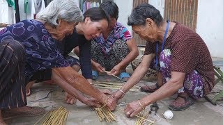 Four women, eight hands, holding down a sorghum pole, laughing, rural only