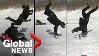 Reporter flipped by sled during news report [OFFICIAL VIDEO]