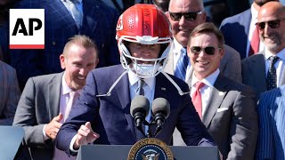 Biden jokes with Travis Kelce, wears Kansas City Chiefs helmet at White House