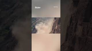 Terrifying moment cliff COLLAPSES yards away from sunbathing beachgoers