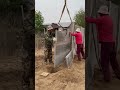 workers installing cement fence