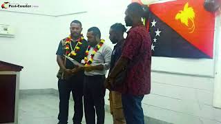 Madang Governor Ramsey Pariwa Presenting the school fee assistance cheque to UPNG Madang Students