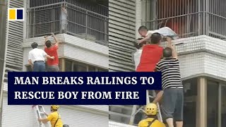 Man in China breaks railings to rescue boy from fire
