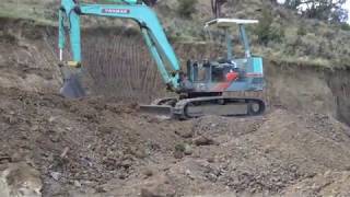 Yanmar YB 451 Excavator Digging On The Hillside