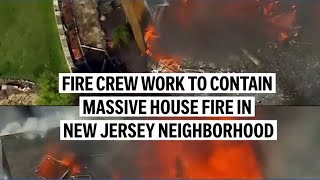 Fire crews work to contain massive blaze in New Jersey neighborhood
