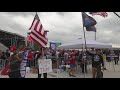 People await former president Trump's arrival outside Atrium Health Amphitheater in Macon