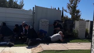 Mourners take cover at cemetery in northern Israel after rockets launched from Lebanon