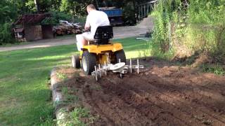 cub cadet 1450 in garden with cultivator