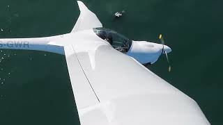 Flying Motor Glider with Trikes over Whales in Wilderness