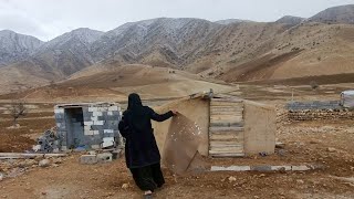 The rural life of a widow with her small children in a hut and winter rain and snow