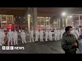 Covid lockdown protest break out in China city after deadly fire - BBC News