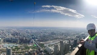 Worker lifts Beijing's China Zun skyscraper to record high