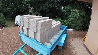 Filling the opening of a rammed earth dwelling with hempcrete blocks.