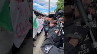Berlin police pull an umbrella from demonstrators during a protest for Gaza… a moment that sparked