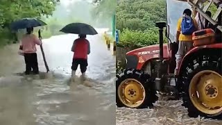 实拍广东清远暴雨：河水暴涨淹没公路村民紧急用拖拉机转移学生