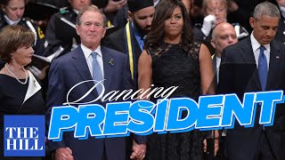 George W. Bush dances during the Dallas Memorial