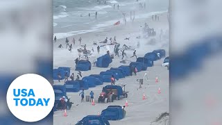 Cameras capture waterspout ripping through crowded beach | USA TODAY