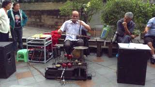 Chongqing, Sichuan: Blind traditional musician at Hongya Cave shopping mall