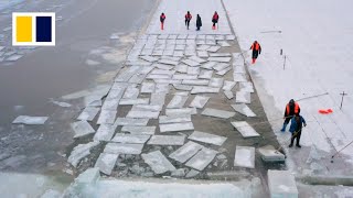 Harbin river ice cutters see incomes melt away as China's temperatures rise