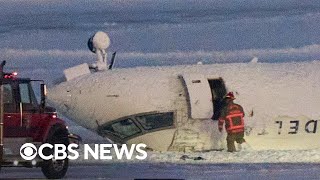 Delta plane crash survivor described hanging upside down after Toronto landing