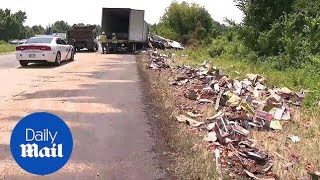 Truck crash sends hundreds of bottles of whisky spilling on road