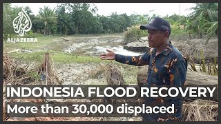 Back to clean up: Indonesia’s displaced flood victims return to Aceh