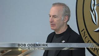 Dr. Bob Odenkirk walks the graduation stage at SIU after 40 years