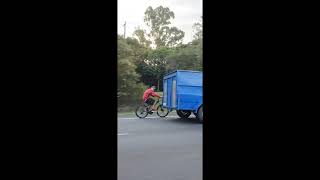 Cyclist Hitches a Ride by Holding Onto Trailer on Queensland Highway