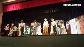 Director Don Johnson leads the cast of Sterling High School's 'The Music Man' in a song during rehea