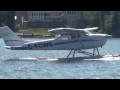 seaplane landing and a sea plane taking off on lake st john ontario canada