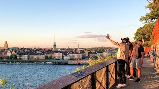 Stockholm Walks on Midsummer´s Eve. Sunset, city view and happy people on Monteliusvägen, Södermalm