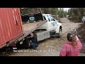 unloading a connex off a truck that s stuck in the mud