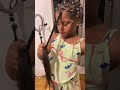 Little girl braids her hair for the first time