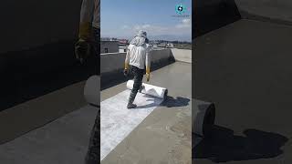 A man is laying a tarp on the roof. Waterproof engineering construction