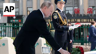 Russian President Putin lays flowers at WWII memorial in Harbin during state visit to China