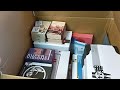 opening a massive mystery box full of art supplies