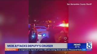 Video shows Southern California street mob attack deputy's cruiser