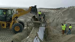 Trapezoidal Sand-Filled Flood Barrier: Sled Deployment