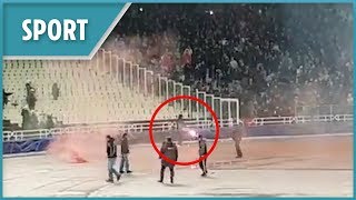 AEK Athens fans throw petrol bomb and fireworks at Ajax supporters