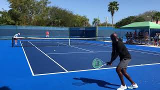 Robbye Poole hitting backhands with Jon Isner