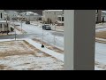 kid hitting curb after sledding down snowy sidewalk