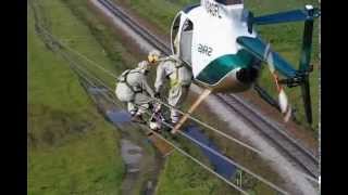 Helicopter Transfering Lineman to Wire