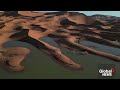 sahara desert flood drone video shows palm trees sand dunes inundated after rare rainfall