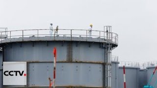 Workers in Japan remove last cover from stricken Fukushima nuclear plant