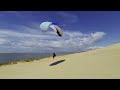 dune du pyla paragliding a beginner girl plays with the wind. gleitschirm