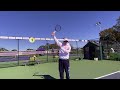 best way to learn a topspin serve hit up up and up as high as you can over the net by rick macci