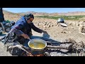 Making Clarified Butter (ghee) from goat butter by a nomadic woman in the traditional way/روغن محلی